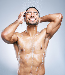 Image showing Man in shower with smile, cleaning and soap for hygiene with shampoo, healthy body and studio backdrop. Water, skin and hair care, happy male model washing with foam on background with bathroom spa.