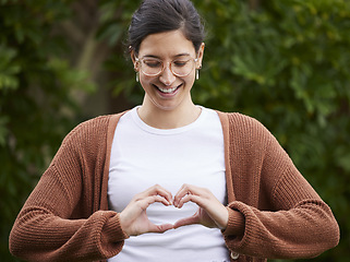 Image showing Love, woman make a heart with her hands and smile for or freedom outdoors. Emoji or happiness, affection and female person with hand gesture for positive motivation or support standing outside