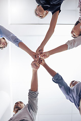 Image showing Circle, business people and fist bump for teamwork, below and motivation in workplace, diversity and solidarity. Businessman, women and team building with hands, support and synergy in modern office