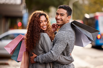 Image showing Happy couple, portrait smile and shopping bags in city together for fashion, gift or buying outdoors. Man and woman in relationship smiling for customer discount, purchase or payment in urban town