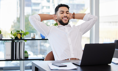 Image showing Laptop, relax and happy business man stretching at a desk after deadline, project and review satisfaction in office. Smile, stretch and Mexican male manager relieved with online development or result