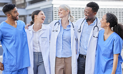 Image showing Doctor team, city and laugh with hug and happiness from healthcare and wellness work. Hospital, nursing and happy clinic group with funny joke and support together by an urban building with a smile