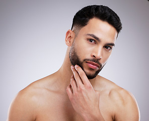 Image showing Skincare, beauty and portrait of man in a studio with a natural, grooming and face routine. Self care, beard trim and male model with a dermatology facial treatment for clear skin by gray background.