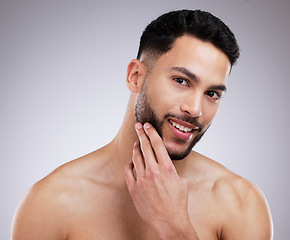 Image showing Skincare, grooming and portrait of happy man in studio with natural, beauty and face routine. Self care, beard trim and male model with dermatology facial treatment for clear skin by gray background.