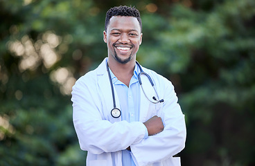 Image showing Black man, doctor portrait and arms crossed of healthcare and wellness professional outdoor. Success, motivation and African male person in nature with a smile from career confidence and work