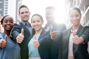 Image showing Diversity, portrait of businesspeople and thumbs up smiling in a city background with a lens flare. Collaboration or teamwork, thank you or success and happy colleagues standing in urban outdoors