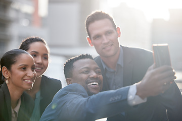 Image showing Diversity, group of people take a selfie and with smartphone smile outdoors in a city background with a lens flare. Happiness, collaboration and colleagues in urban street together with smile