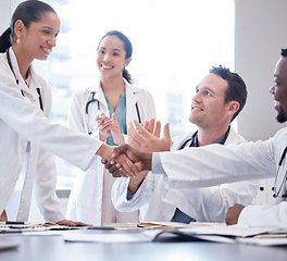 Image showing Doctors, staff or meeting with handshake, applause or congratulations with healthcare innovation, wellness or opportunity. Group, team or coworkers clapping, shaking hands or partnership with growth