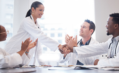 Image showing Doctors, staff and meeting with handshake, applause or promotion with healthcare innovation, growth or opportunity. Group, team or coworkers brainstorming, clapping or shaking hands with medical cure