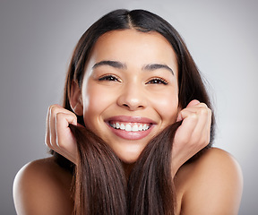 Image showing Portrait, beauty and woman with hair care, smile and luxury treatment against a grey studio background. Face, female person or happy model with grooming routine, happiness and clean scalp with volume