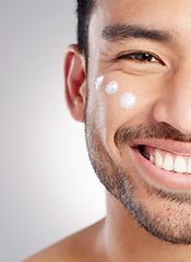 Image showing Closeup, portrait and man with skincare, cream and dermatology against grey studio background. Face, male person and model with lotion, creme and grooming routine with a smile, beauty and smooth skin