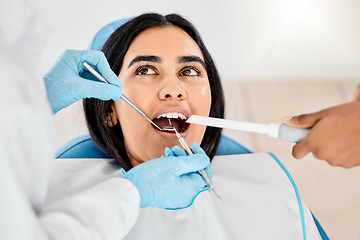 Image showing Dentist, woman and patient at a clinic with medical and healthcare for teeth whitening. Mirror, orthodontist and female person with wellness and dental work tool in mouth with care and cleaning