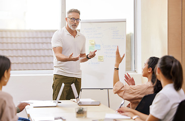 Image showing Business, presentation and man in a meeting, questions and feedback with corporate training, share ideas and speaking. Male person, leader or group in a workshop, review or brainstorming in an office