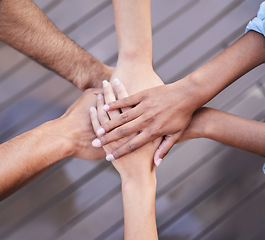 Image showing Top view of teamwork, hands and people in circle, support and collaboration of trust, motivation or success. Closeup, community and helping hand of group for goals, mission and partnership in synergy