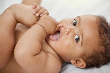 Image showing Baby, portrait and child play with feet on bed in home having fun and enjoying time alone. Face, newborn and playing with foot, toes and cute infant, kid or toddler with growth, development and relax