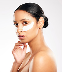 Image showing Woman, portrait and eye mask for skincare, beauty or cosmetics against a white studio background. Face of female person or model with facial collagen pads under eyes for anti aging or dermatology