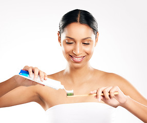 Image showing Happy woman, toothbrush and toothpaste for clean teeth, dental or hygiene against a white studio background. Female person or model with product for brushing mouth, oral or gum care on mockup space