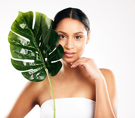 Image showing Woman, portrait and leaf for natural skincare, beauty or organic cosmetics against a white studio background. Face of female person or model with green plant, leaves or dermatology for sustainability