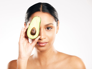 Image showing Woman, portrait and avocado on face in skincare, natural beauty or nutrition against a white studio background. Female person or model with organic fruit or vegetable for healthy skin, diet or facial