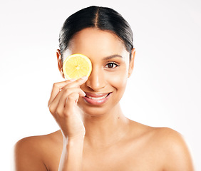 Image showing Happy woman, portrait and face with lemon for vitamin C, diet or skincare against a white studio background. Female person smile with citrus fruit for healthy nutrition, natural collagen or facial