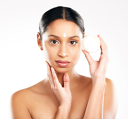 Image showing Woman, portrait and cream for skincare, beauty or cosmetics against a white studio background. Face of female person or model with product, lotion or skin creme in dermatology for facial treatment