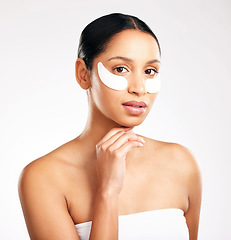 Image showing Woman, portrait and eye patches for skincare, beauty or cosmetics against a white studio background. Face of female person or model with facial collagen pads under eyes for anti aging or dermatology