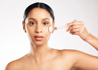 Image showing Woman, portrait and face with derma roller in skincare, dermatology or beauty against a white studio background. Female person or model rolling skin in healthy wellness, self care or facial treatment