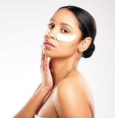 Image showing Woman, portrait and eye pads for skincare, beauty or cosmetics against a white studio background. Face of female person or model with facial collagen mask under eyes for anti aging or dermatology