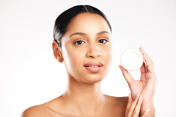 Image showing Woman, portrait and face cream for skincare, beauty or cosmetics against a white studio background. Female person with container product, lotion or skin creme for dermatology or facial treatment