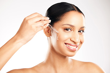 Image showing Happy woman, face and serum for skincare, hydration or healthcare in retinol dermatology against a grey studio background. Portrait of female person with dropper for vitamin C, collagen or facial oil