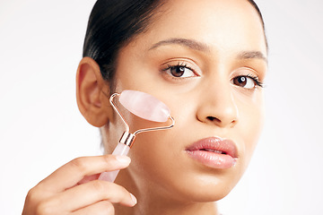 Image showing Woman, portrait and face with derma roller in healthcare, skincare or dermatology against a white studio background. Female person or model rolling skin for beauty, self care or facial treatment