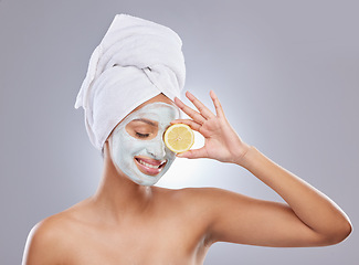 Image showing Mask, skincare and lemon with woman in studio for beauty, natural cosmetics and vitamin c. Self care, glow and spa with face of female model and citrus fruit on grey background for detox product