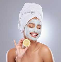 Image showing Mask, skincare and lemon with face of woman in studio for beauty, natural cosmetics and vitamin c. Self care, glow and spa with female model and citrus fruit on grey background for detox product