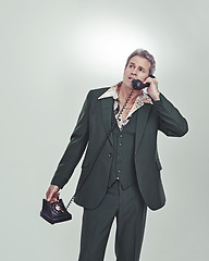 Image showing Give me the biggest one you got. Cropped studio shot of a mature man in a retro suit talking on an old-fashioned telephone.