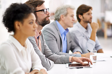 Image showing Project debriefing. Shot of a group of dedicated business professionals sitting in a row.