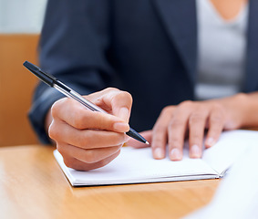 Image showing Putting pen to paper...Closeup image of a businesswoman writing in a notebook.