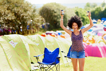 Image showing She loves the summer sun. An attractive young woman standing outside during a festival.