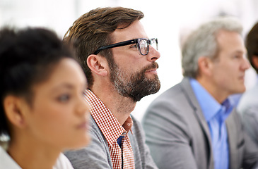 Image showing Project debriefing. Shot of a group of dedicated business professionals sitting in a row.