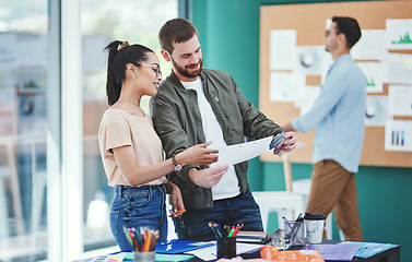 Image showing Its about leaving a mark with their brand. Shot of two young designers having a discussion in an office.