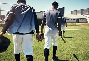 Image showing It was a game to remember. Rearview shot of a group of young men walking onto a baseball field.