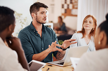 Image showing Setting out some clear objectives. Shot of a young businessman having a meeting with his colleagues in an office.