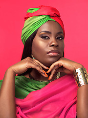 Image showing I feel like a queen in this attire. Studio portrait of a beautiful young woman wearing a cultural attire and jewellery against a pink background.