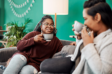 Image showing With good coffee comes good conversation. Shot of two young women having coffee and chatting on the sofa at home.