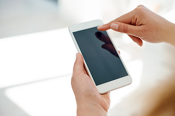 Image showing Shes always been well connected in the business world. Cropped shot of an unrecognizable businesswoman using her smartphone inside of an office.