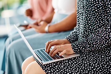 Image showing Her notes will be safer digitally. Cropped shot of a group of unrecognizable businesswomen using wireless technology while sitting in line in a modern office.