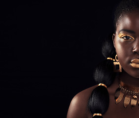 Image showing Half, portrait and black woman in studio with gold, luxury and makeup on black background. Glitter, face and African female model with wealth, glow and jewellery, elegance and posing royal aesthetic