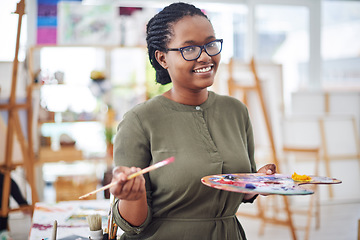 Image showing You are a work of art. Cropped shot of a young woman holding an artists palette in a art studio.