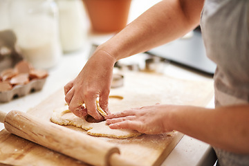 Image showing Getting my cookies ready for the oven. Cropped shot of an unrecognizable woman cutting out cookies in her kitchen.