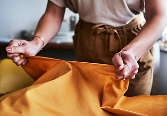 Image showing I only need half of this. Cropped shot of an unrecognizable designer working with fabric in her workshop.