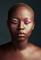 Image showing Who needs black and white when you can shine in color. Cropped shot of a beautiful woman wearing colorful eyeshadow while posing against a grey background.